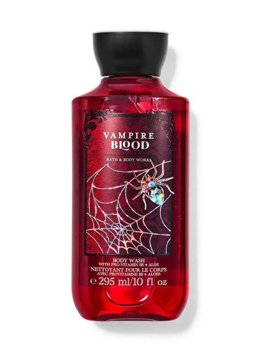 Red bottle of VAMPIRE BLOOD body wash, 295 ml, with a spider web design, offering fruity and floral scent, enriched with provitamin B5 and aloe.